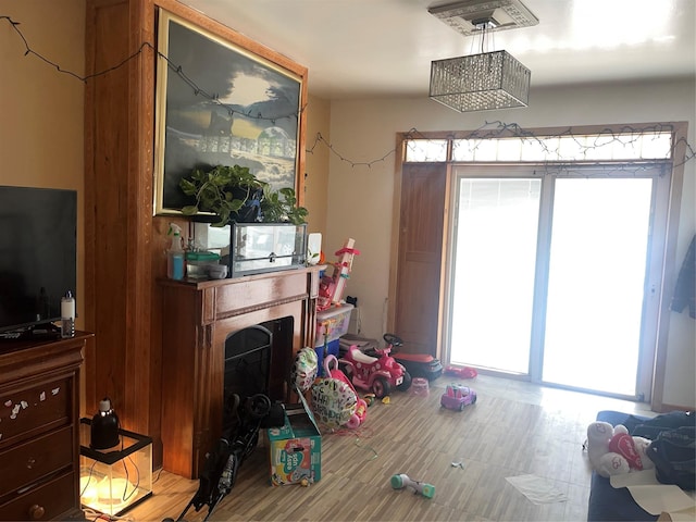living room featuring plenty of natural light, a fireplace, and wood finished floors
