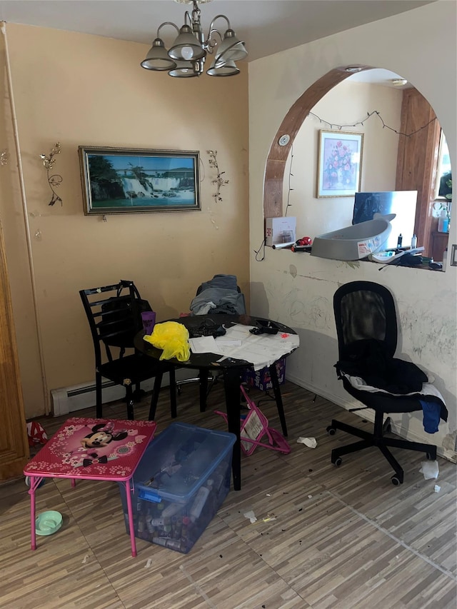 office space with baseboard heating, a chandelier, and wood finished floors