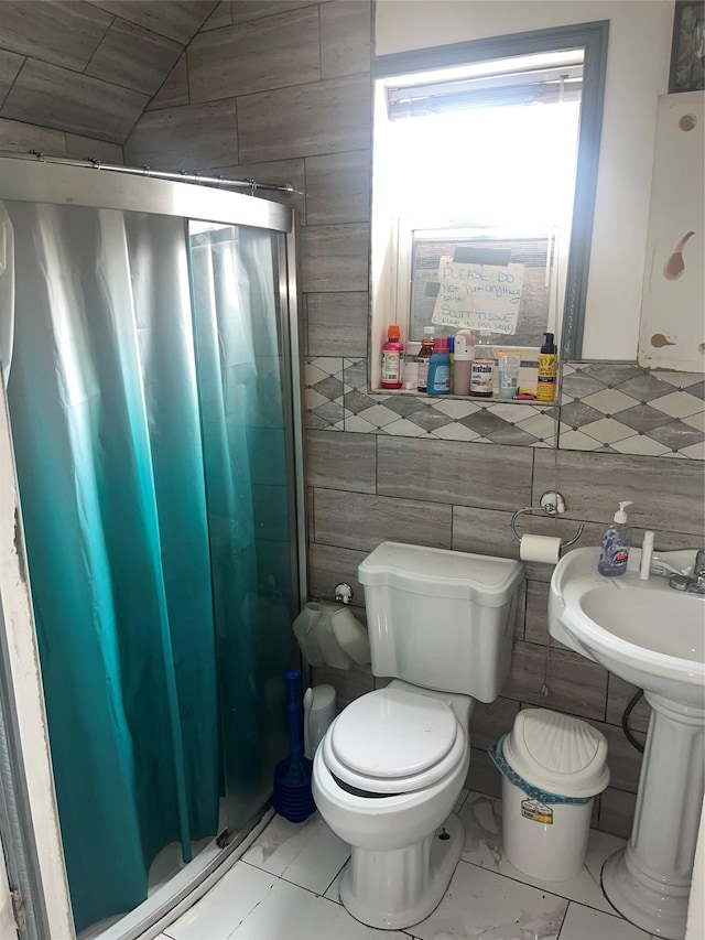 bathroom with toilet and marble look tiles
