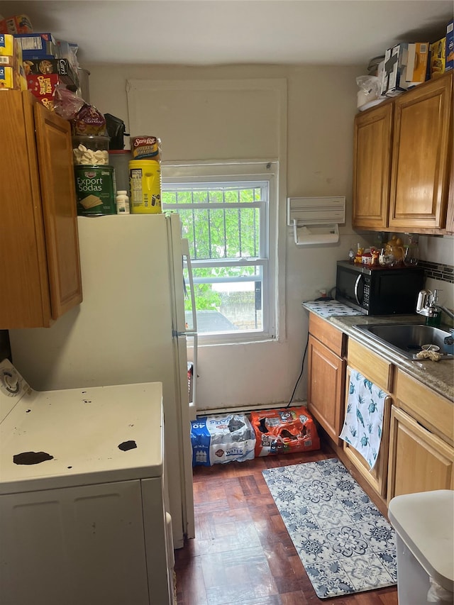 555 Hemlock St, Brooklyn, NY 11208 - kitchen featuring washer / dryer, black microwave, a sink, brown cabinetry, and light countertops