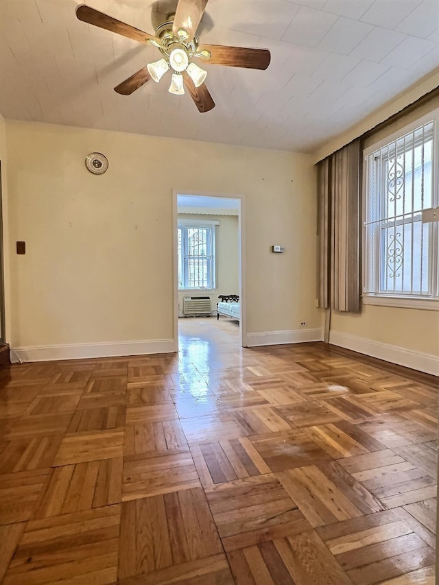 spare room featuring baseboards and a ceiling fan