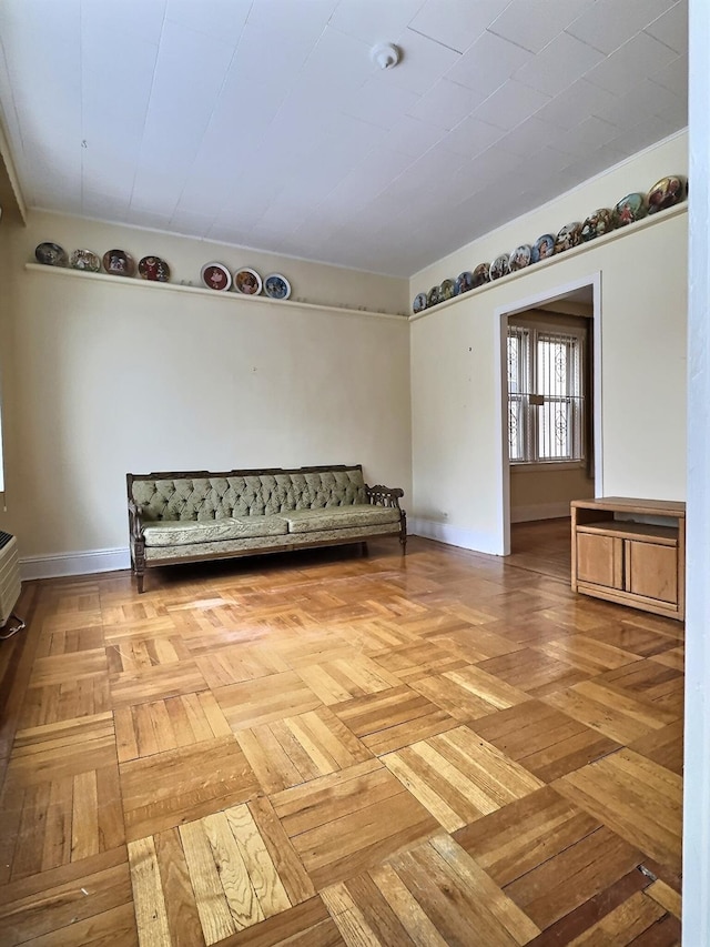 unfurnished room with baseboards