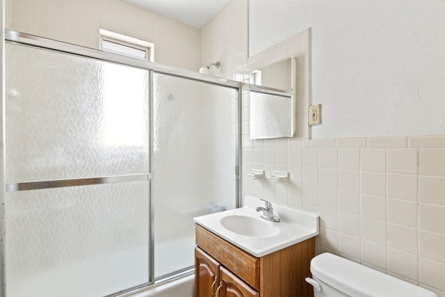 20-58 35th St, Astoria, NY 11105 - bathroom with toilet, tile walls, vanity, and combined bath / shower with glass door