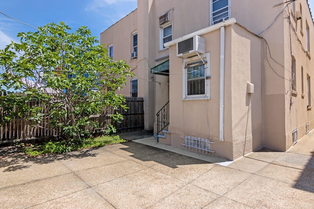 20-58 35th St, Astoria, NY 11105 - view of property with fence and a wall mounted AC