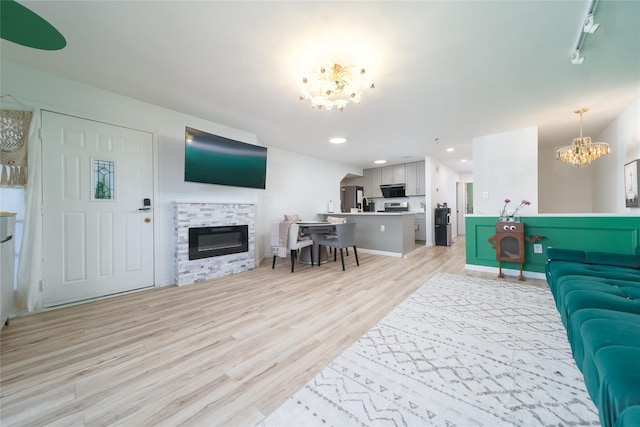 240-48 Oak Park Dr Unit A, Douglaston, NY 11362 - living area with a chandelier, light wood-style flooring, a fireplace, recessed lighting, and baseboards