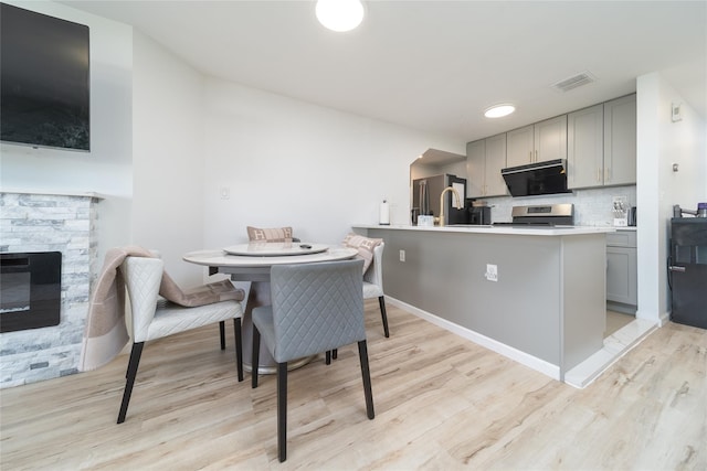 240-48 Oak Park Dr Unit A, Douglaston, NY 11362 - kitchen with gray cabinetry, appliances with stainless steel finishes, and light wood-style floors