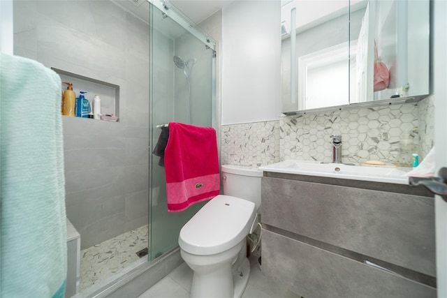 240-48 Oak Park Dr Unit A, Douglaston, NY 11362 - full bathroom with a shower stall, tile patterned flooring, toilet, vanity, and tile walls