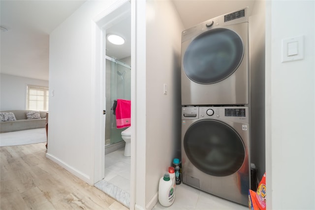 240-48 Oak Park Dr Unit A, Douglaston, NY 11362 - laundry area featuring stacked washer / dryer, wood finished floors, and baseboards