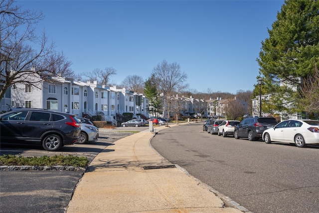 240-48 Oak Park Dr Unit A, Douglaston, NY 11362 - view of asphalt road featuring a residential view, sidewalks, and curbs