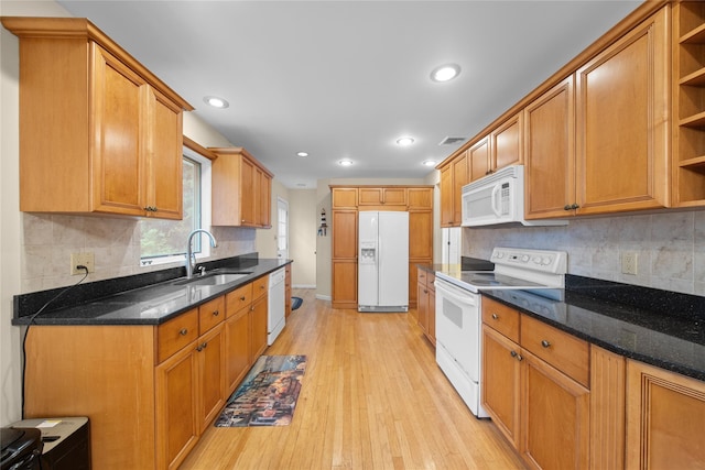 kitchen with white appliances, visible vents, a sink, open shelves, and light wood-style floors
