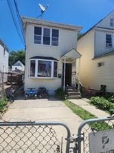 back of property with a fenced front yard and a gate