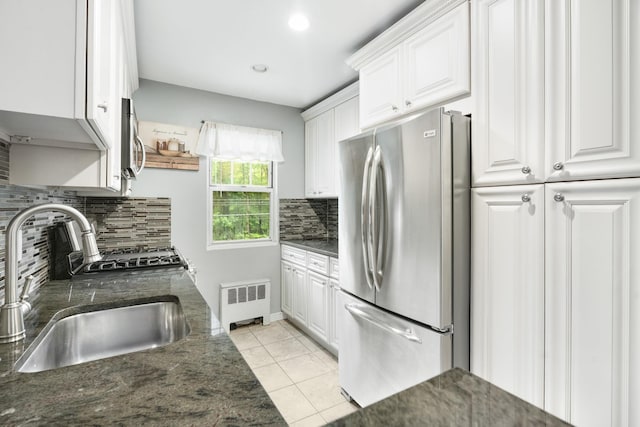 70 Underhill Ave Unit 1A, West Harrison, NY 10604 - kitchen with appliances with stainless steel finishes, white cabinetry, radiator, light tile patterned floors, and a sink