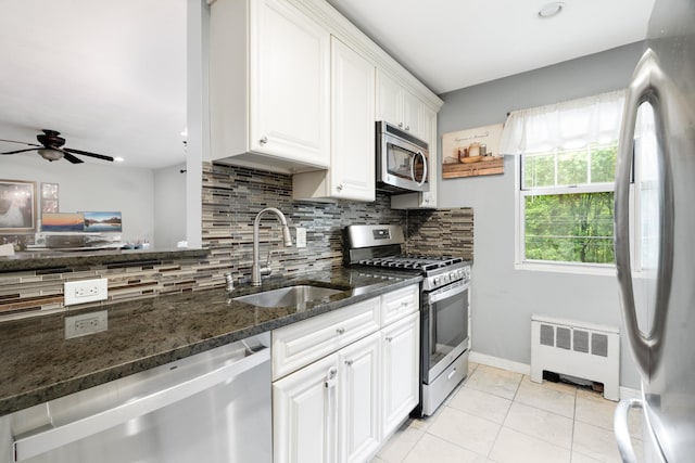 70 Underhill Ave Unit 1A, West Harrison, NY 10604 - kitchen featuring radiator, stainless steel appliances, a sink, and decorative backsplash