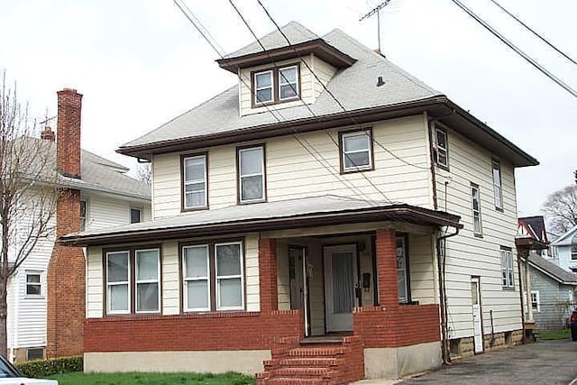 traditional style home featuring brick siding