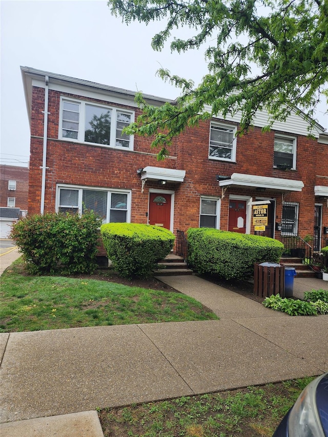 townhome / multi-family property with brick siding