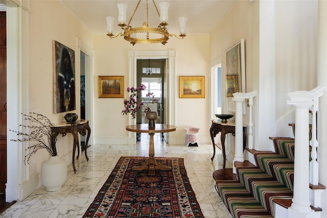 hall featuring an inviting chandelier, baseboards, and marble finish floor
