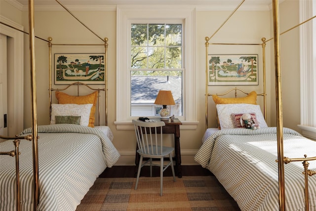 bedroom with crown molding, wood finished floors, baseboards, and multiple windows