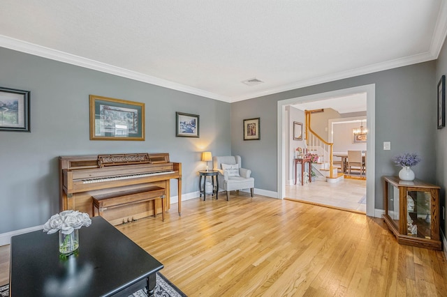 7 Jacqueline Ct, Port Jefferson Station, NY 11776 - sitting room with a chandelier, crown molding, light wood finished floors, and stairway
