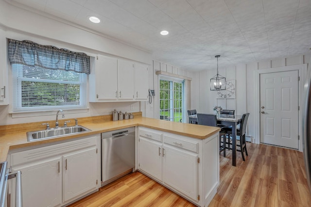 7 Jacqueline Ct, Port Jefferson Station, NY 11776 - kitchen with dishwasher, light countertops, white cabinetry, and a peninsula