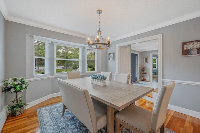 7 Jacqueline Ct, Port Jefferson Station, NY 11776 - dining space featuring a chandelier, plenty of natural light, light wood finished floors, and ornamental molding