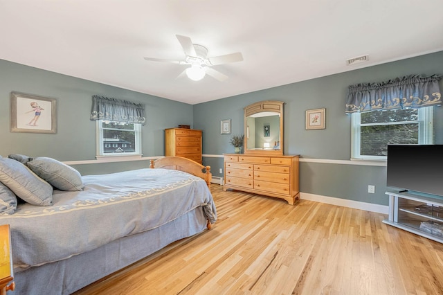 7 Jacqueline Ct, Port Jefferson Station, NY 11776 - bedroom with wood finished floors, a baseboard heating unit, and a ceiling fan