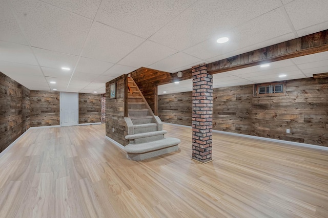 7 Jacqueline Ct, Port Jefferson Station, NY 11776 - finished below grade area with a drop ceiling, wood walls, wood finished floors, and stairs