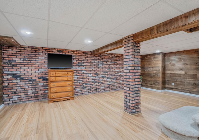 7 Jacqueline Ct, Port Jefferson Station, NY 11776 - finished basement with a paneled ceiling, brick wall, and wood finished floors