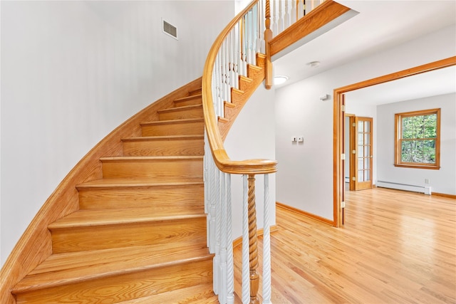 521 Plattekill Ardonia Rd, Wallkill, NY 12589 - stairway with a baseboard heating unit, wood finished floors, and baseboards