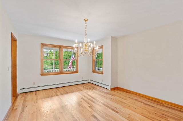 521 Plattekill Ardonia Rd, Wallkill, NY 12589 - spare room featuring a chandelier, light wood finished floors, baseboard heating, and baseboards