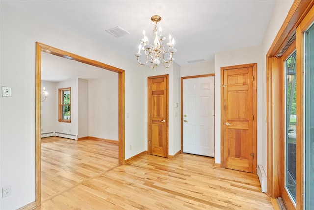 521 Plattekill Ardonia Rd, Wallkill, NY 12589 - foyer featuring a chandelier, a baseboard heating unit, and light wood-style floors
