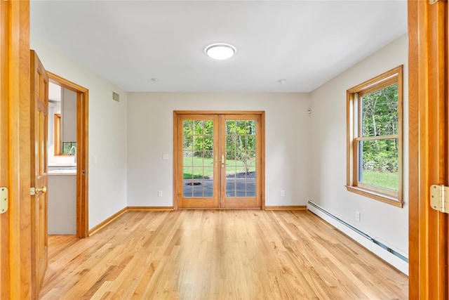 521 Plattekill Ardonia Rd, Wallkill, NY 12589 - spare room featuring a baseboard heating unit, light wood-style floors, healthy amount of natural light, and baseboards