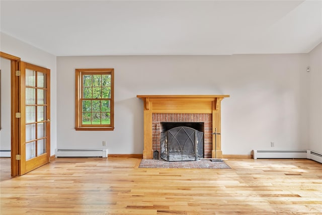521 Plattekill Ardonia Rd, Wallkill, NY 12589 - unfurnished living room with a baseboard radiator, wood finished floors, a brick fireplace, and baseboards