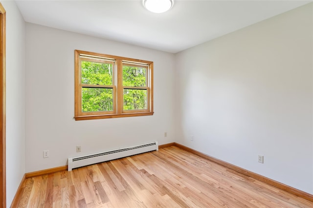 521 Plattekill Ardonia Rd, Wallkill, NY 12589 - empty room featuring a baseboard heating unit, light wood-style flooring, and baseboards