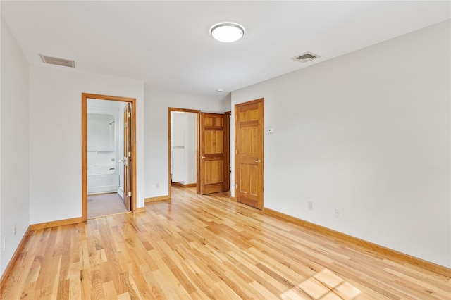 521 Plattekill Ardonia Rd, Wallkill, NY 12589 - unfurnished bedroom with light wood finished floors, baseboards, and ensuite bathroom