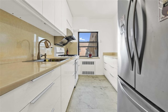 kitchen with freestanding refrigerator, white gas range oven, modern cabinets, and light marble finish floors