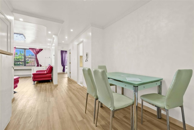 dining space featuring radiator, ornamental molding, wood finished floors, recessed lighting, and baseboards