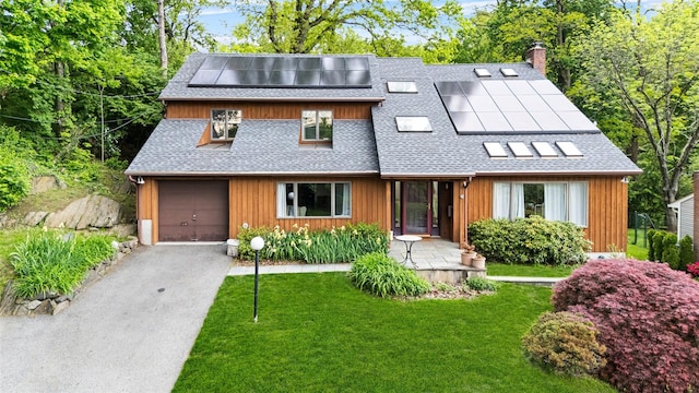 8 Wolf Rd, Croton-On-Hudson, NY 10520 - view of front of house featuring roof with shingles, a front lawn, solar panels, a chimney, and a garage