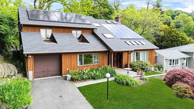 8 Wolf Rd, Croton-On-Hudson, NY 10520 - view of front of home with a shingled roof, roof mounted solar panels, a chimney, asphalt driveway, and a front lawn