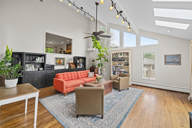 8 Wolf Rd, Croton-On-Hudson, NY 10520 - living room featuring a baseboard heating unit, plenty of natural light, a skylight, wood finished floors, and high vaulted ceiling