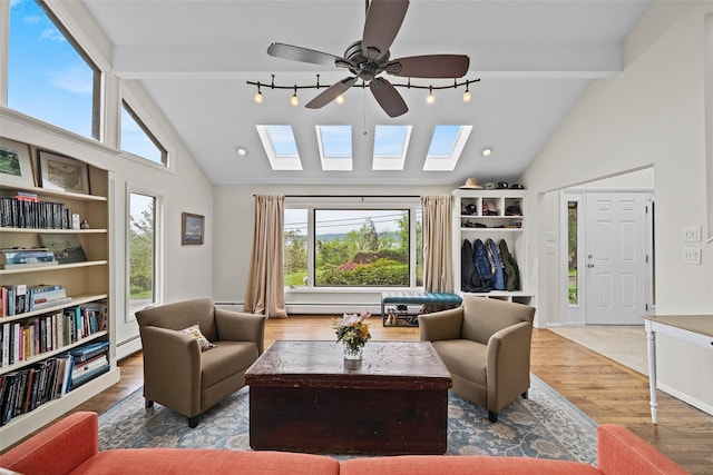 8 Wolf Rd, Croton-On-Hudson, NY 10520 - living room featuring a skylight, plenty of natural light, a baseboard heating unit, ceiling fan, and beamed ceiling