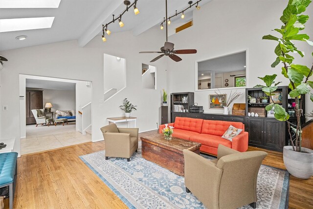 8 Wolf Rd, Croton-On-Hudson, NY 10520 - living room with wood finished floors, a skylight, a ceiling fan, and stairway