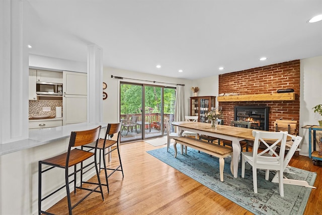 8 Wolf Rd, Croton-On-Hudson, NY 10520 - dining space featuring a fireplace, light wood-type flooring, and recessed lighting