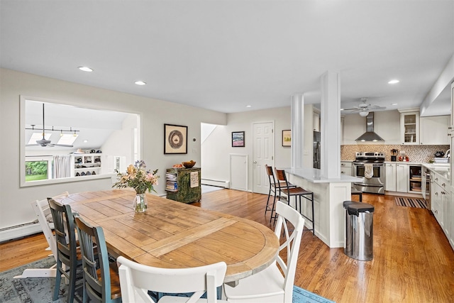 8 Wolf Rd, Croton-On-Hudson, NY 10520 - dining space with ceiling fan, beverage cooler, light wood-style flooring, a baseboard heating unit, and recessed lighting