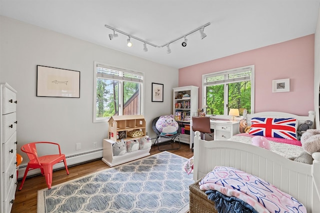 8 Wolf Rd, Croton-On-Hudson, NY 10520 - bedroom featuring baseboard heating, wood finished floors, and track lighting