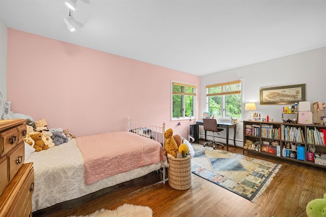 8 Wolf Rd, Croton-On-Hudson, NY 10520 - bedroom featuring wood finished floors, a baseboard heating unit, and an office area