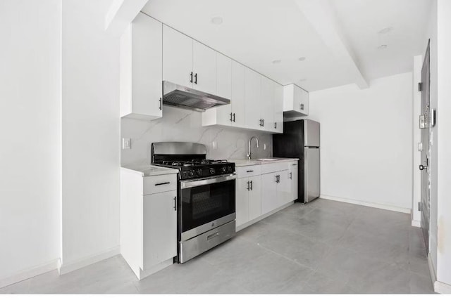 kitchen featuring under cabinet range hood, decorative backsplash, light countertops, white cabinets, and appliances with stainless steel finishes
