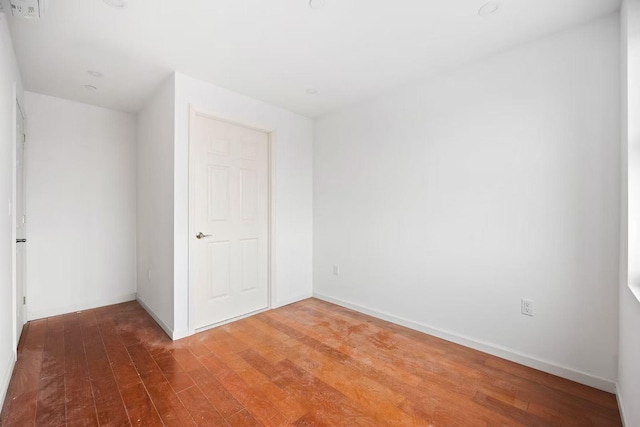 unfurnished bedroom with baseboards and wood finished floors