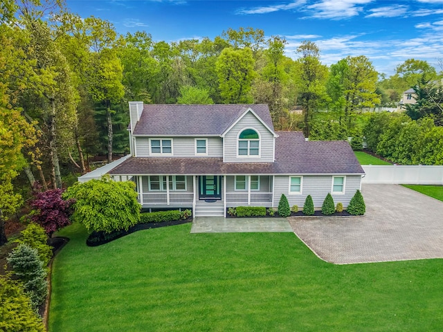 56 N Woods Rd, Baiting Hollow, NY 11933 - view of front of home with a chimney, a porch, roof with shingles, and a front yard