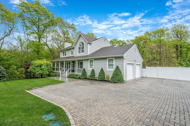 56 N Woods Rd, Baiting Hollow, NY 11933 - view of front of home featuring covered porch, an attached garage, roof with shingles, and decorative driveway
