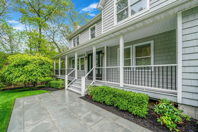 56 N Woods Rd, Baiting Hollow, NY 11933 - view of exterior entry featuring covered porch